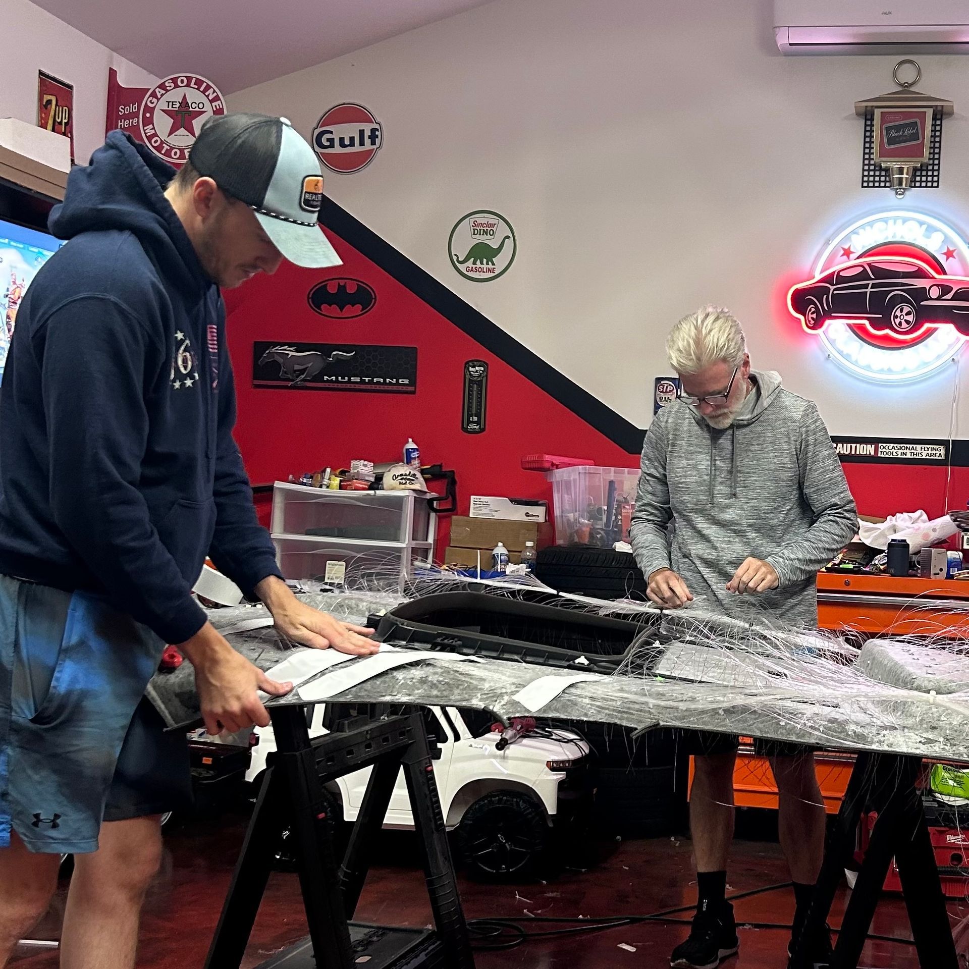 Technicians Installing Custom Lighting Inside Auto Shop | Nichols Auto Repair