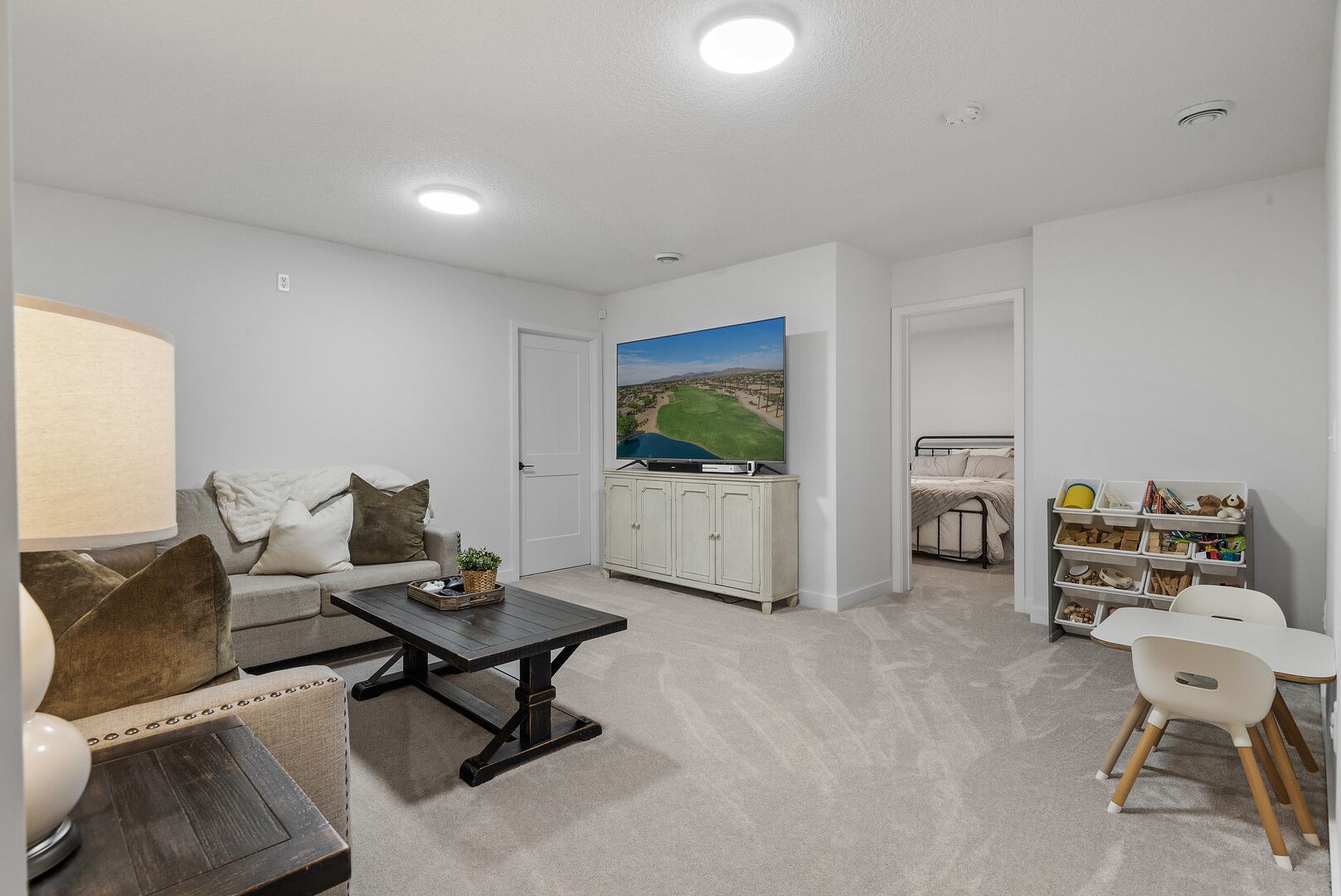 House exterior with blue siding, white trim, and stone entry. Red roses in front.