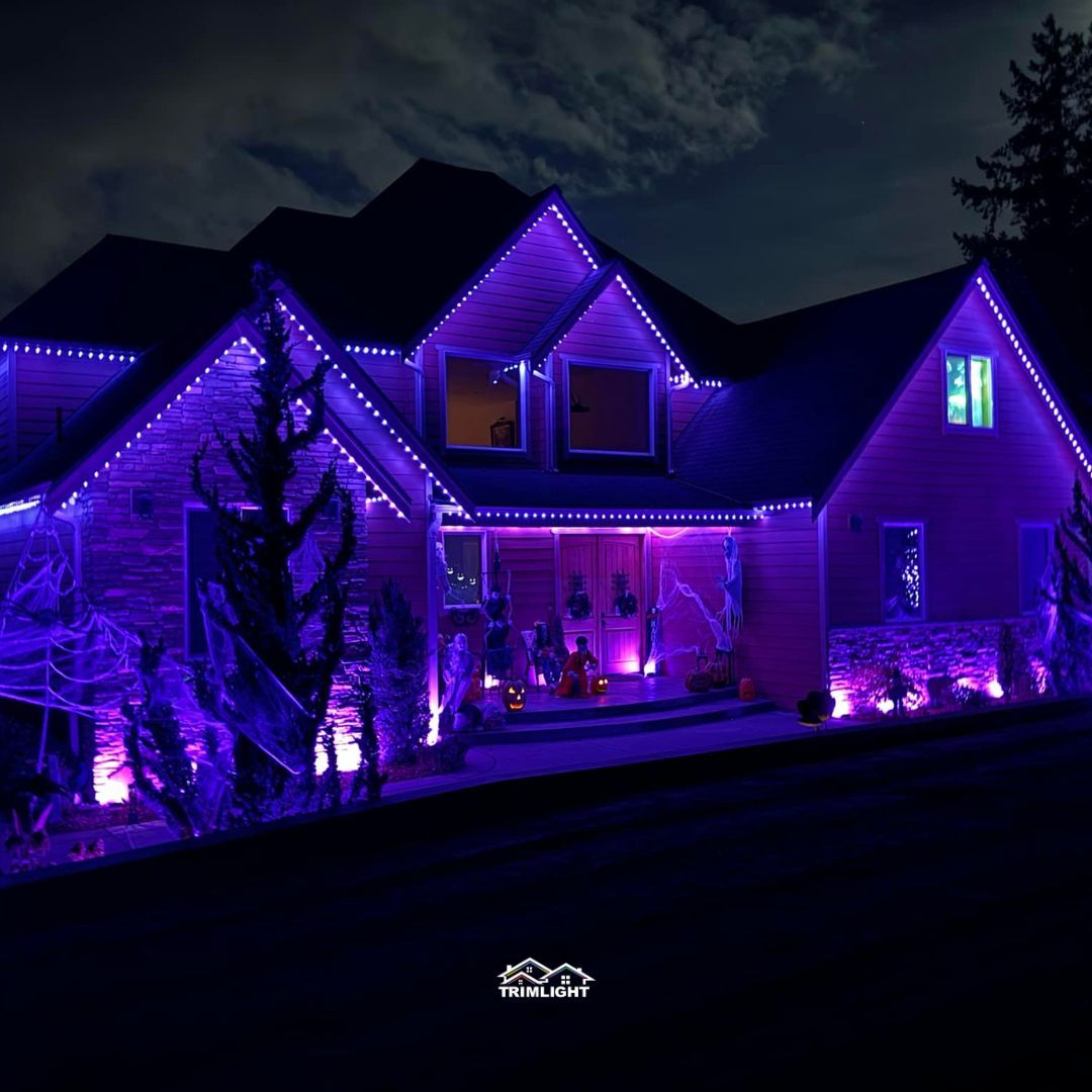 House decorated for Halloween with purple lights.