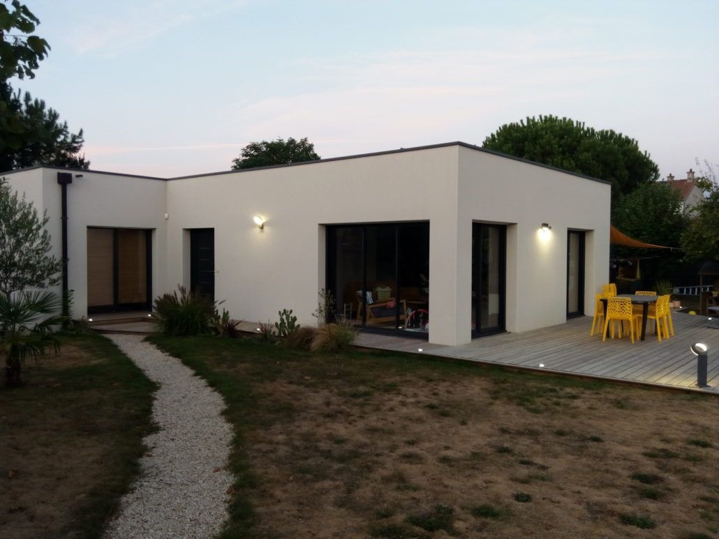 Une maison blanche avec des chaises jaunes devant