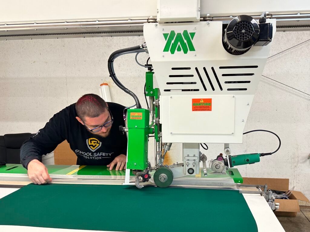 A man is working on a machine that says yay on it