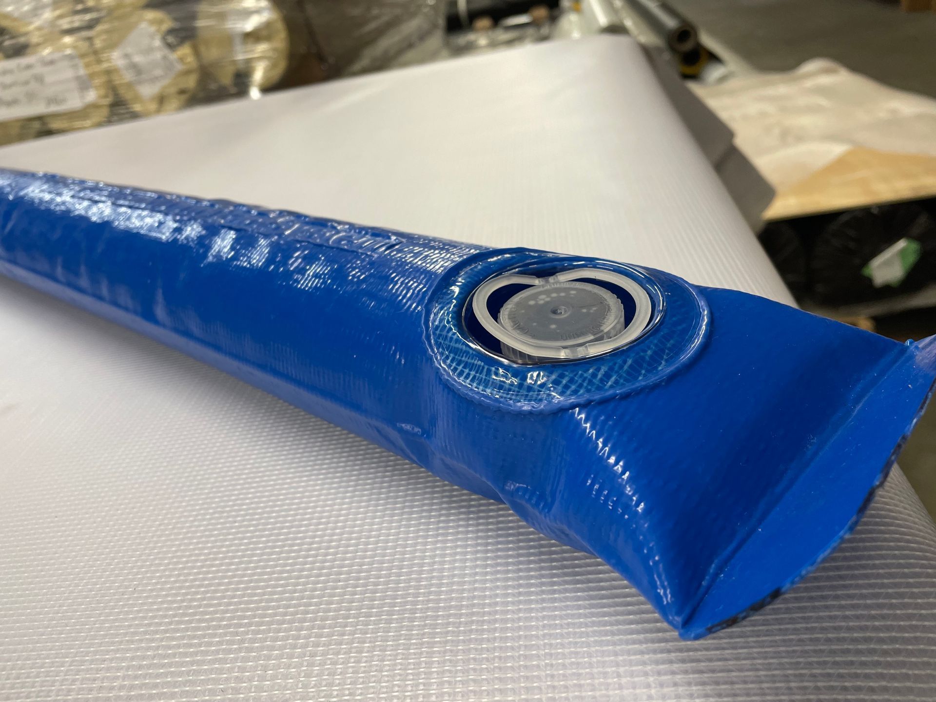 A blue tube with a hole in the middle of it