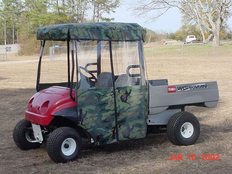 A golf cart with a camouflage cover on it