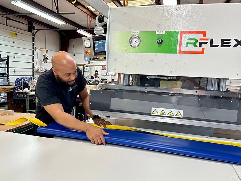 A man is working on a machine in a factory.