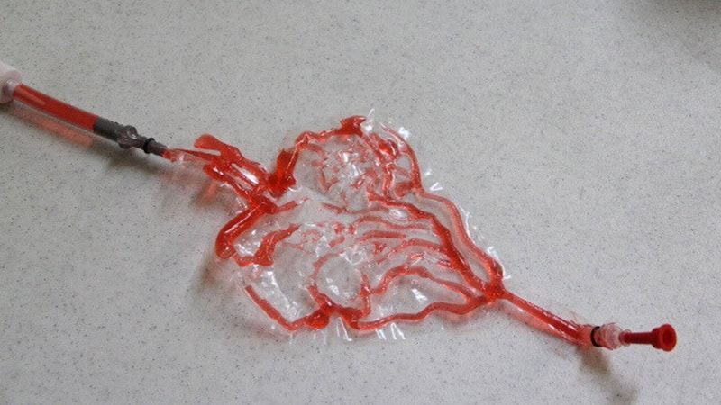 A syringe with a red liquid coming out of it