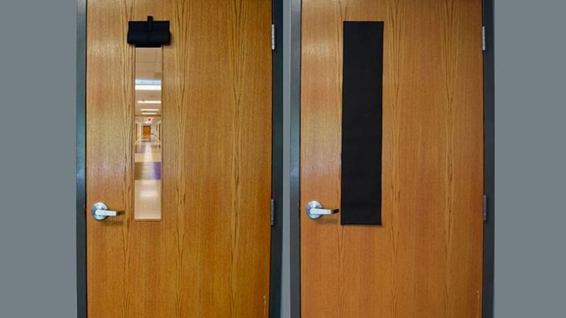 A pair of wooden doors with a black handle and a window.