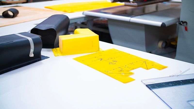 A yellow block is sitting on top of a white table.