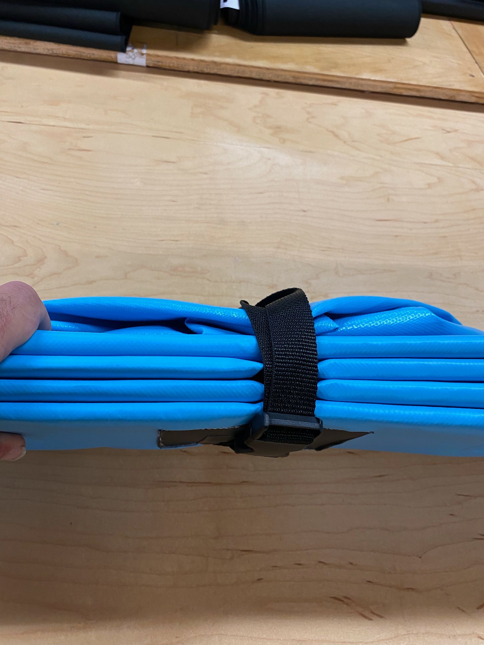 A person is holding a bunch of blue cables that were converted from rigid to flexible.