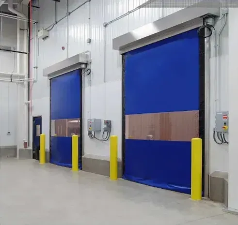 A row of blue doors in a building with yellow poles.