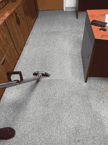 Office carpeted hallway with a wheelchair footrest and a desk chair partially blocking the path