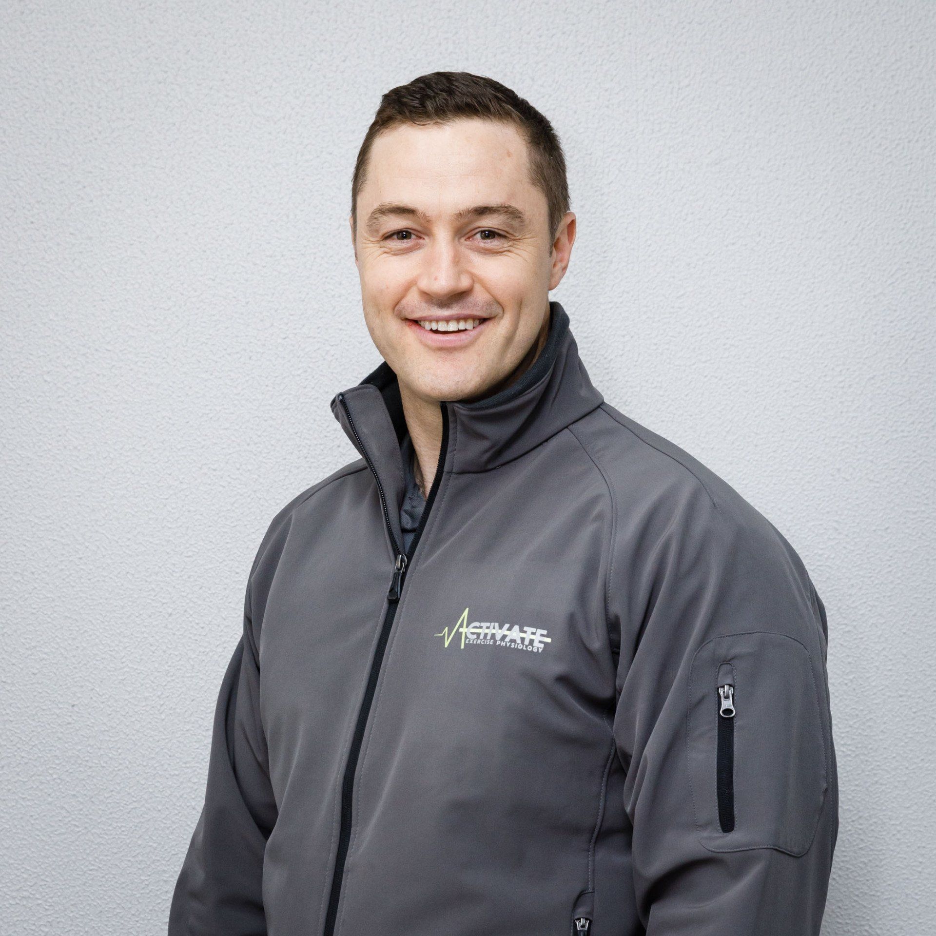 A man wearing a grey jacket with the word aerhaff on it