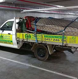 Truck is Parked in a Parking Garage Filled With Furniture — Rob's Rubbish Removal in Byron Bay, NSW