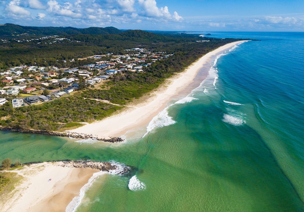 Aerial View of a Coastal Town With a Sandy Beach Meeting — Rob's Rubbish Removal in Pottsville, NSW