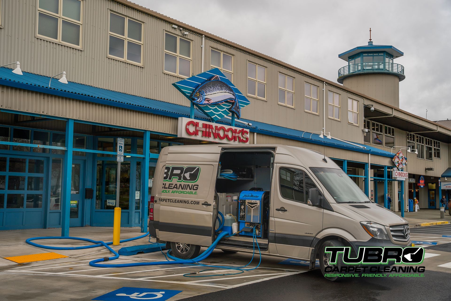 A van is parked in front of a building with the door open.