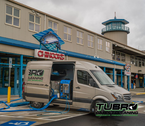 A van is parked in front of a building with the door open