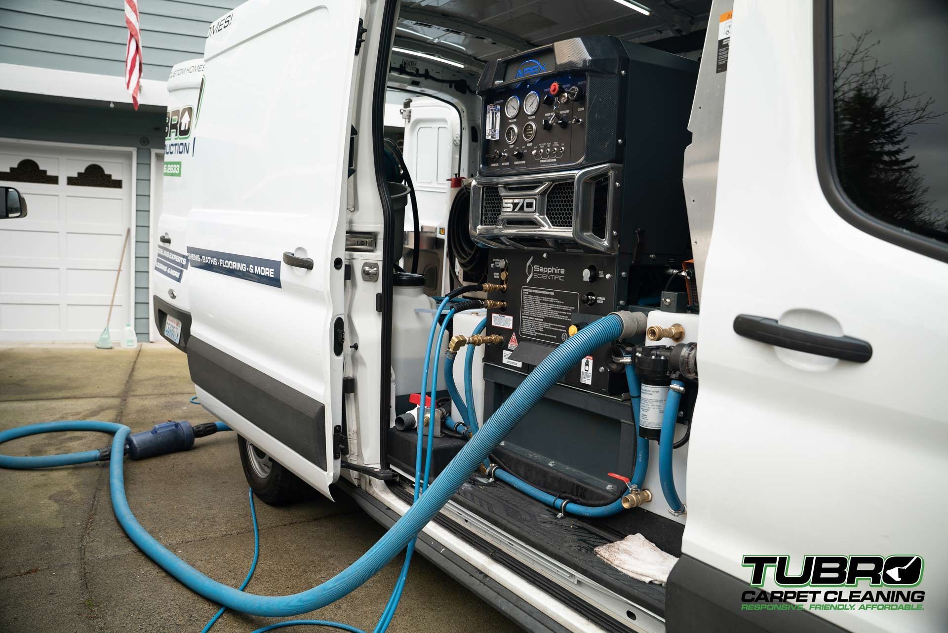 A white van with a hose attached to the back of it