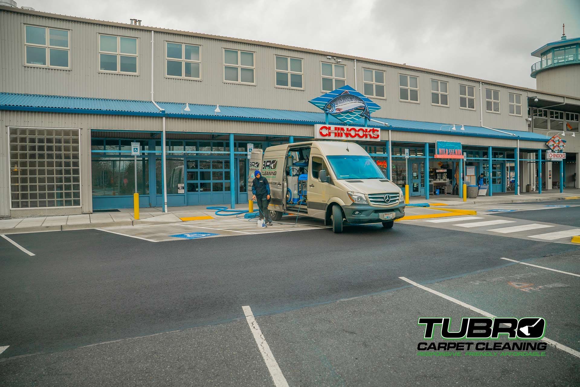 A white van is parked in front of a building that says carpet cleaning