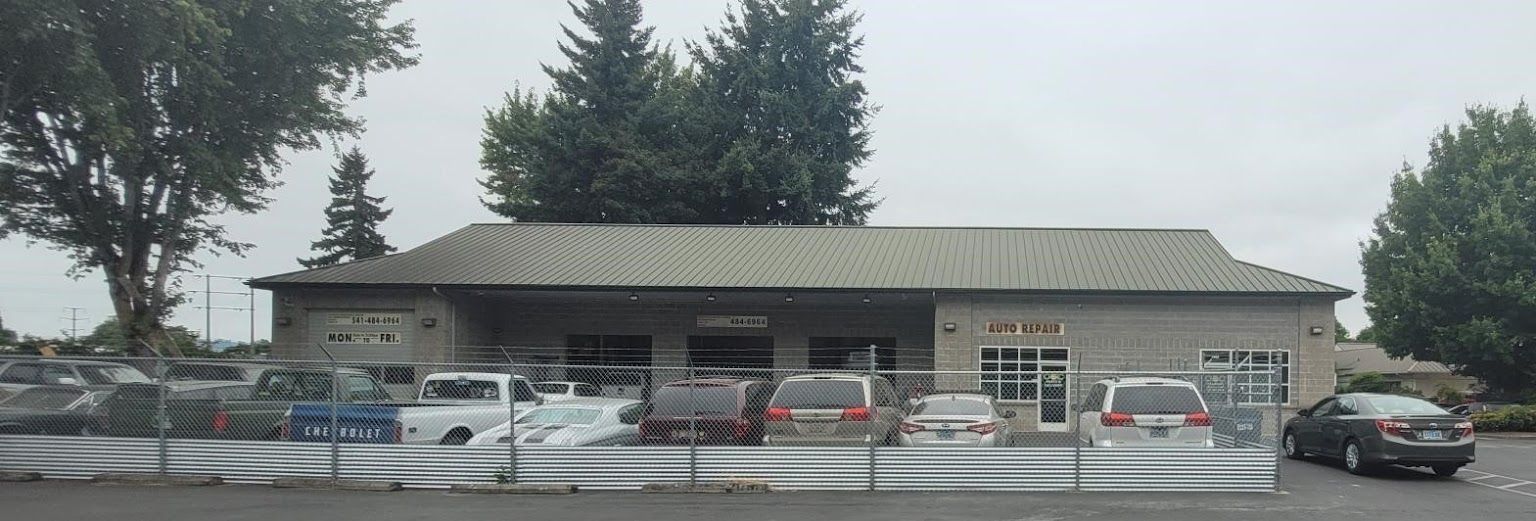 A building with a lot of cars parked in front of it. | Oakmont Service Center