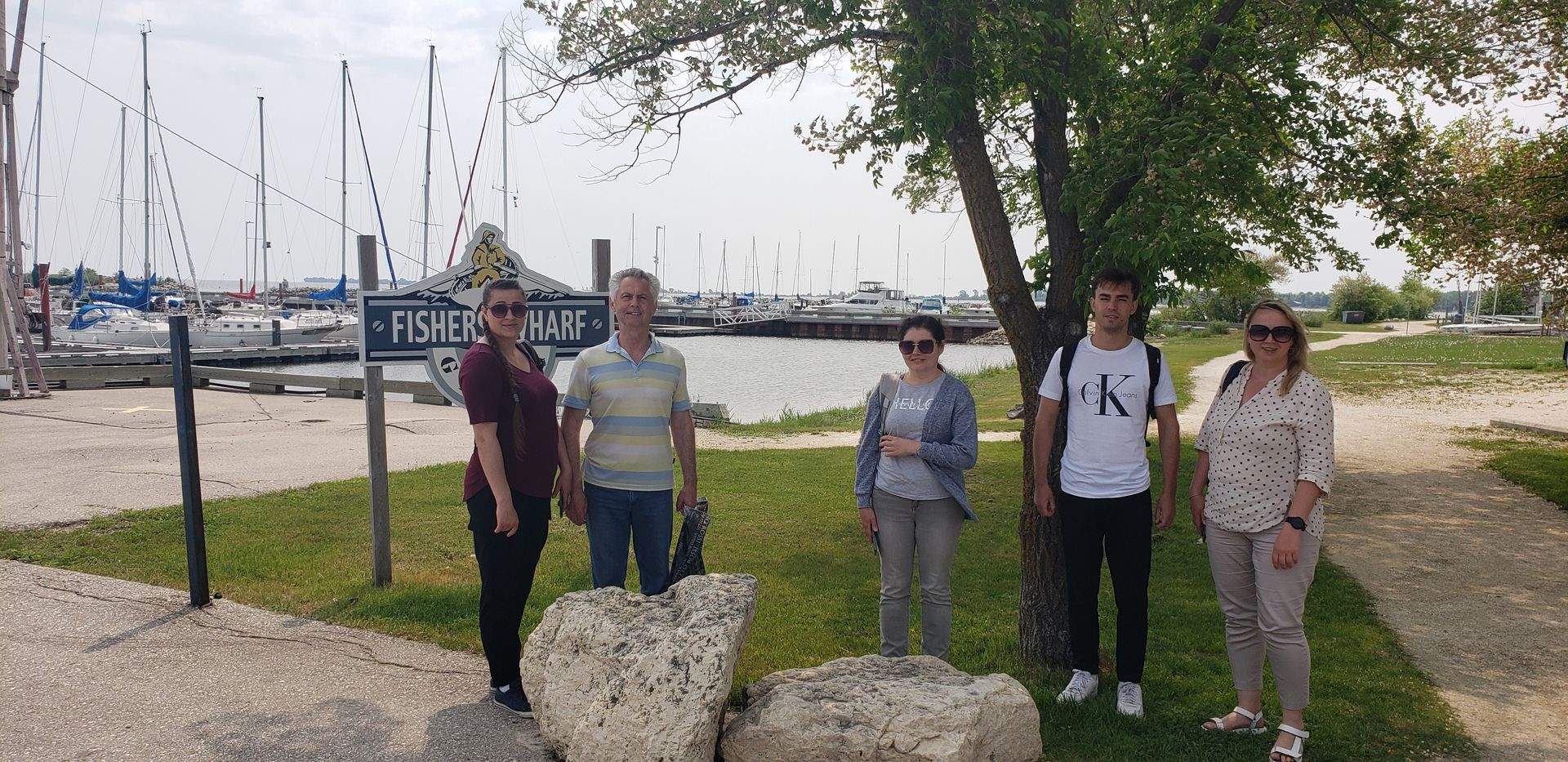 A group of people standing next to each other in a park.