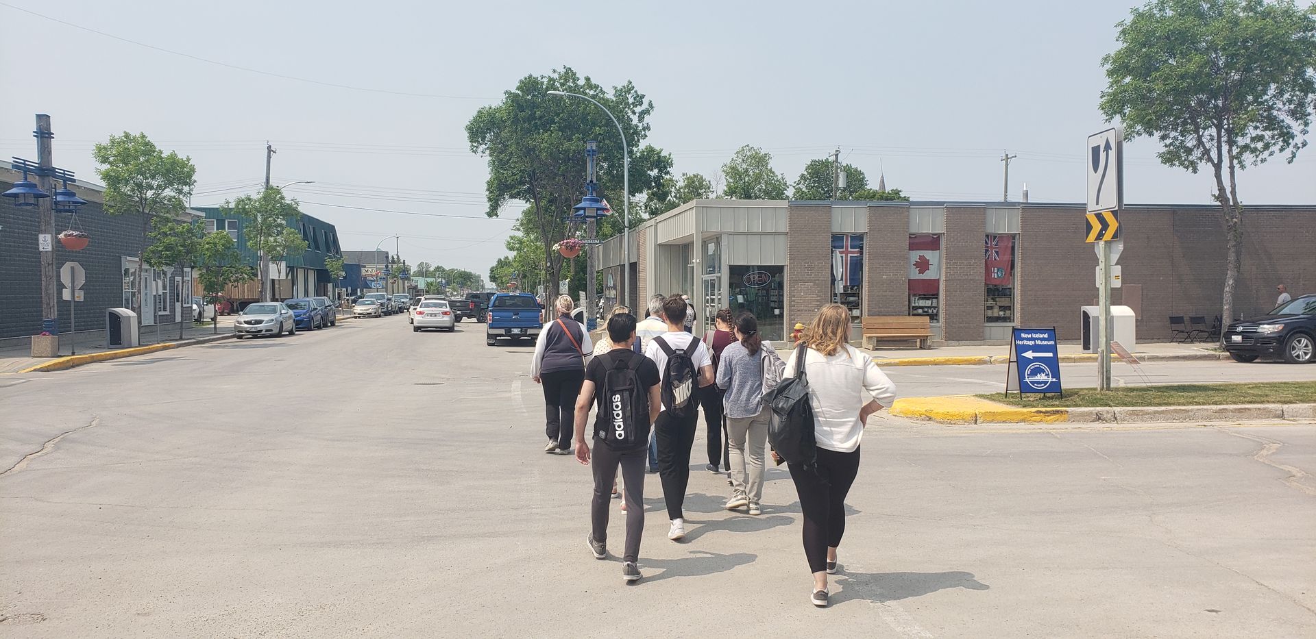 A group of people are walking down a city street.