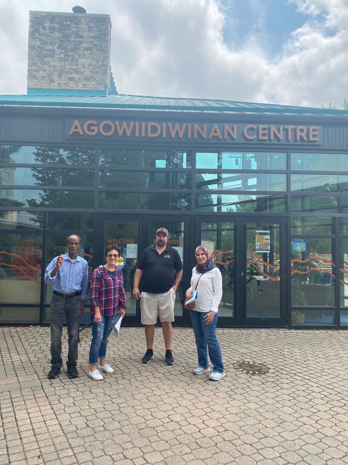 A group of people are standing in front of a building.