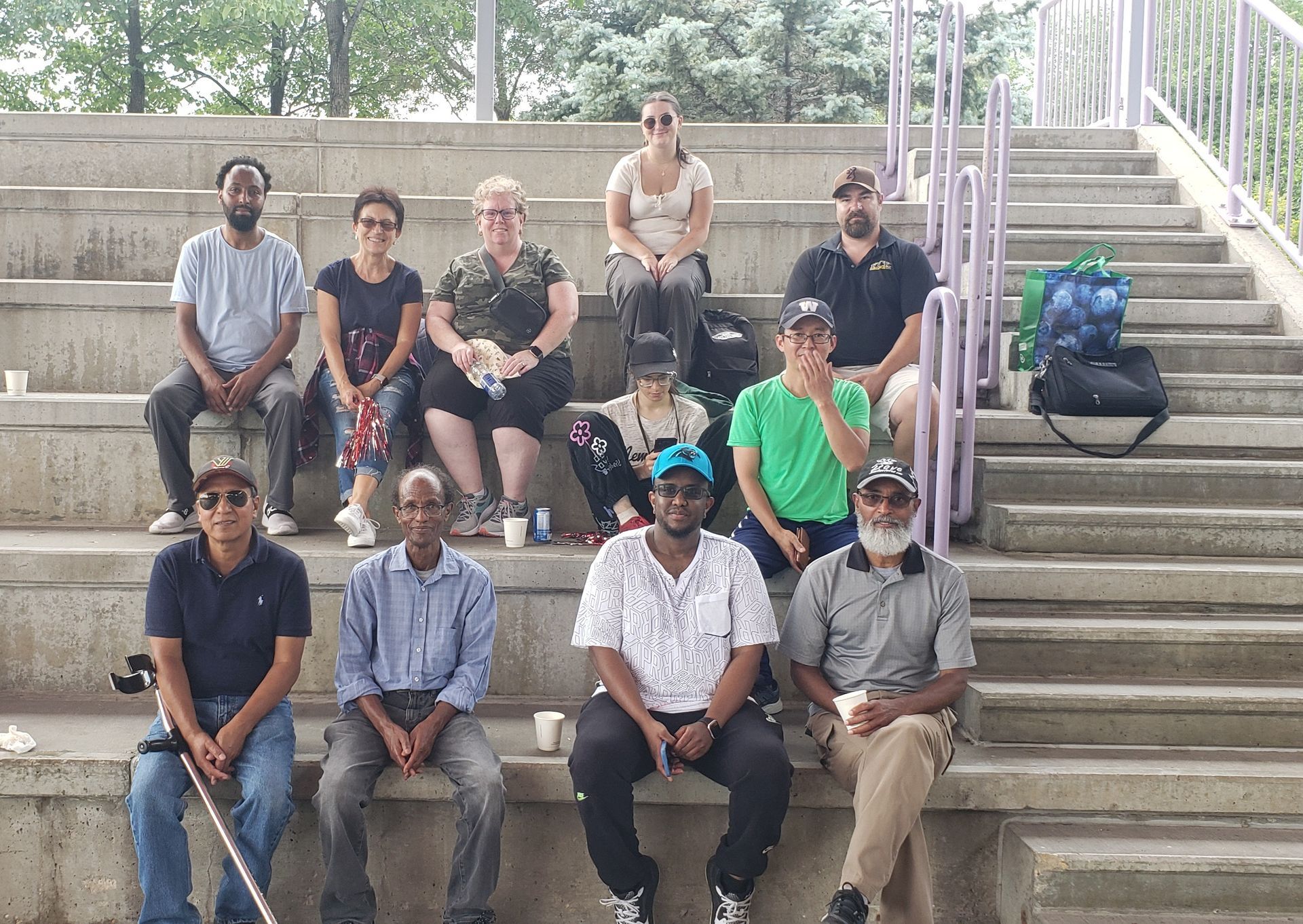A group of people are sitting on a set of stairs.