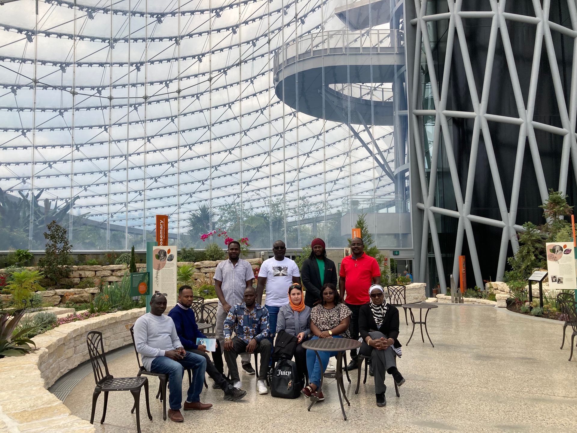 A group of people are posing for a picture in front of a building.