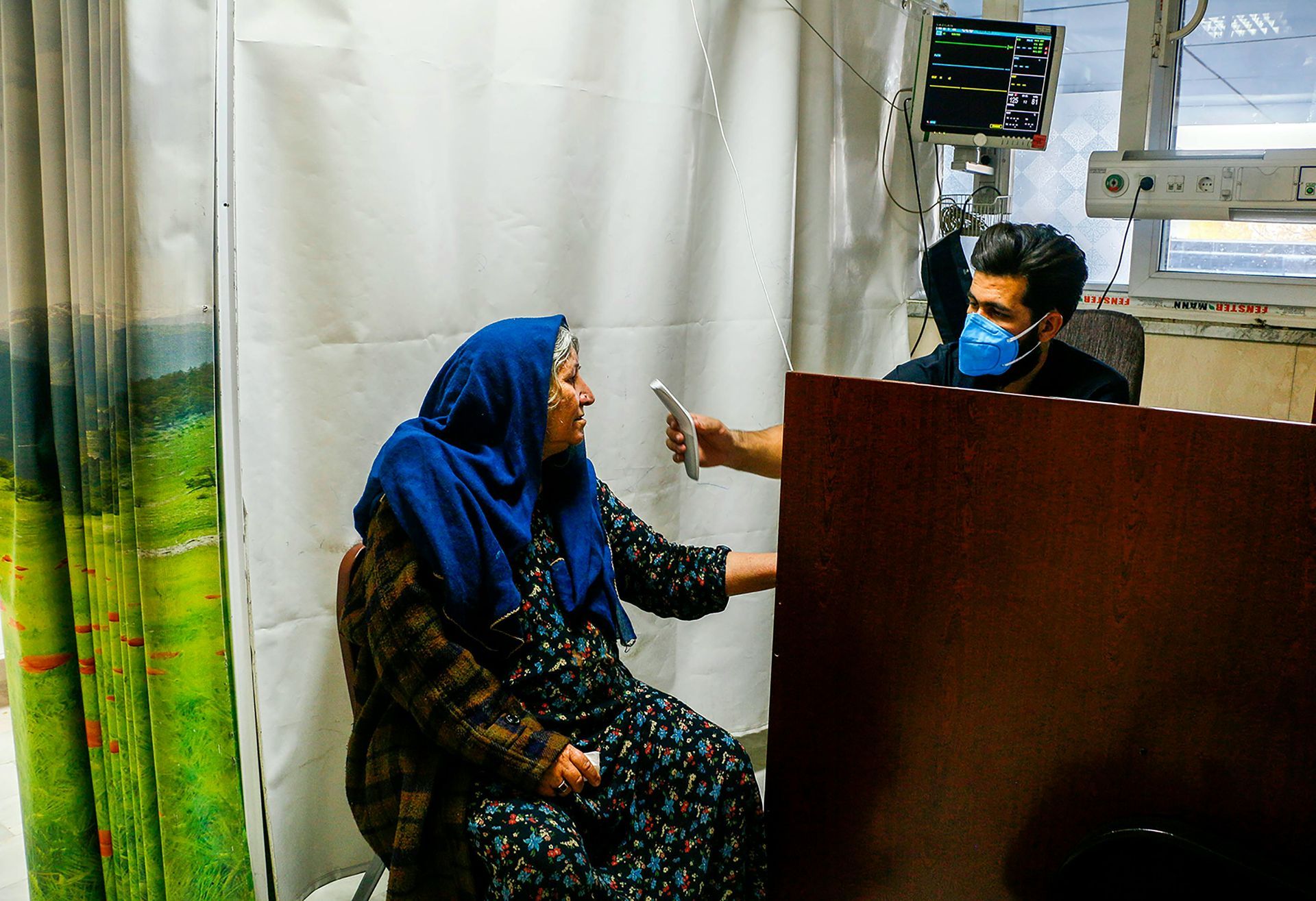 Historic street scene with buildings and figures, some near a horse-drawn cart. A steeple is visible in the distance.