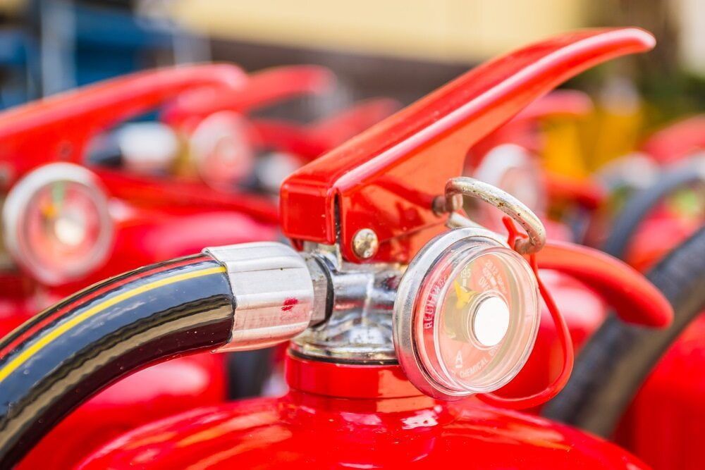 A Close Up of a Fire Extinguisher With a Hose Attached to It — East-West Fire Services In Proserpine, QLD