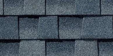 Close-up of dark blue asphalt roof shingles.