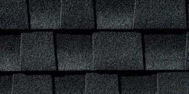 Black asphalt roof shingles in a close-up view.