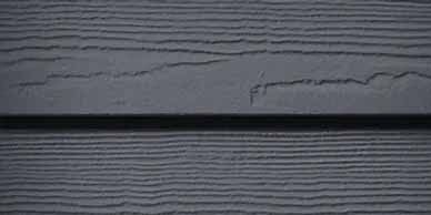 Gray wood siding with horizontal grooves and a dark line.