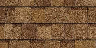 Close-up of brown asphalt roofing shingles arranged in overlapping rows.