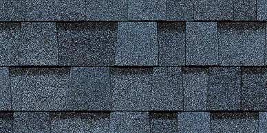 Close-up of blue-gray asphalt roof shingles arranged in overlapping rows.