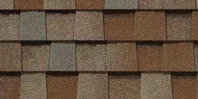 Close-up of brown, tan, and gray asphalt shingles on a roof.