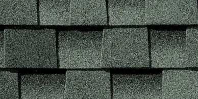 Close-up of gray asphalt roof shingles arranged in overlapping rows.