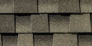Close-up of asphalt roof shingles in shades of brown and gray.