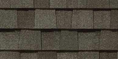 Close-up of a textured, dark-grey asphalt shingle roof.