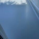 Light blue car hood, shadows from above.