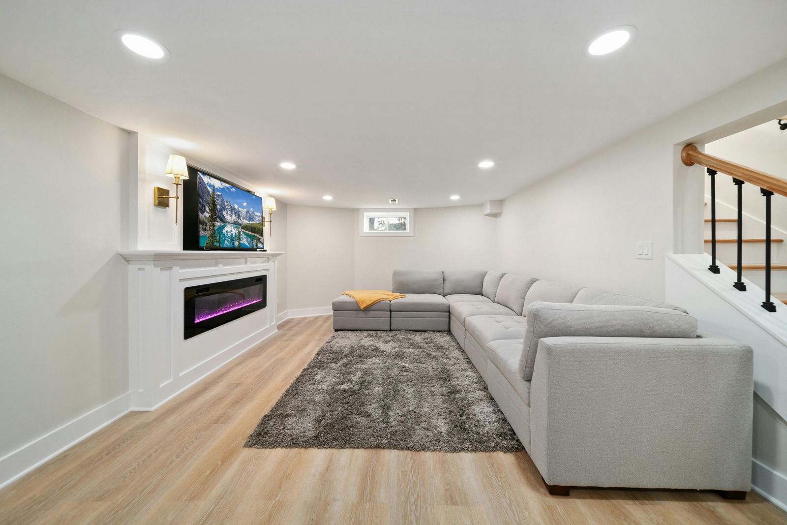 Construction site with underground pipes in trench, buildings in the background.