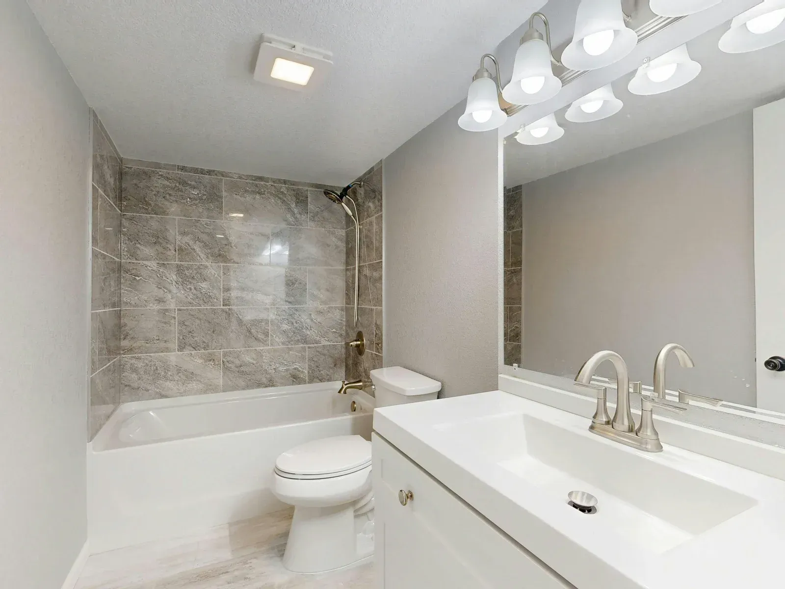 Construction site with underground pipes in trench, buildings in the background.