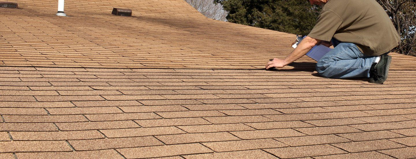 Construction site with underground pipes in trench, buildings in the background.