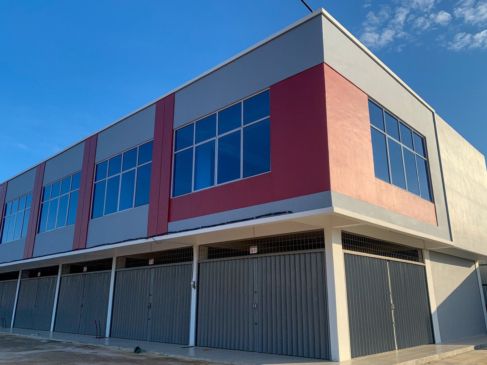 Construction site with underground pipes in trench, buildings in the background.