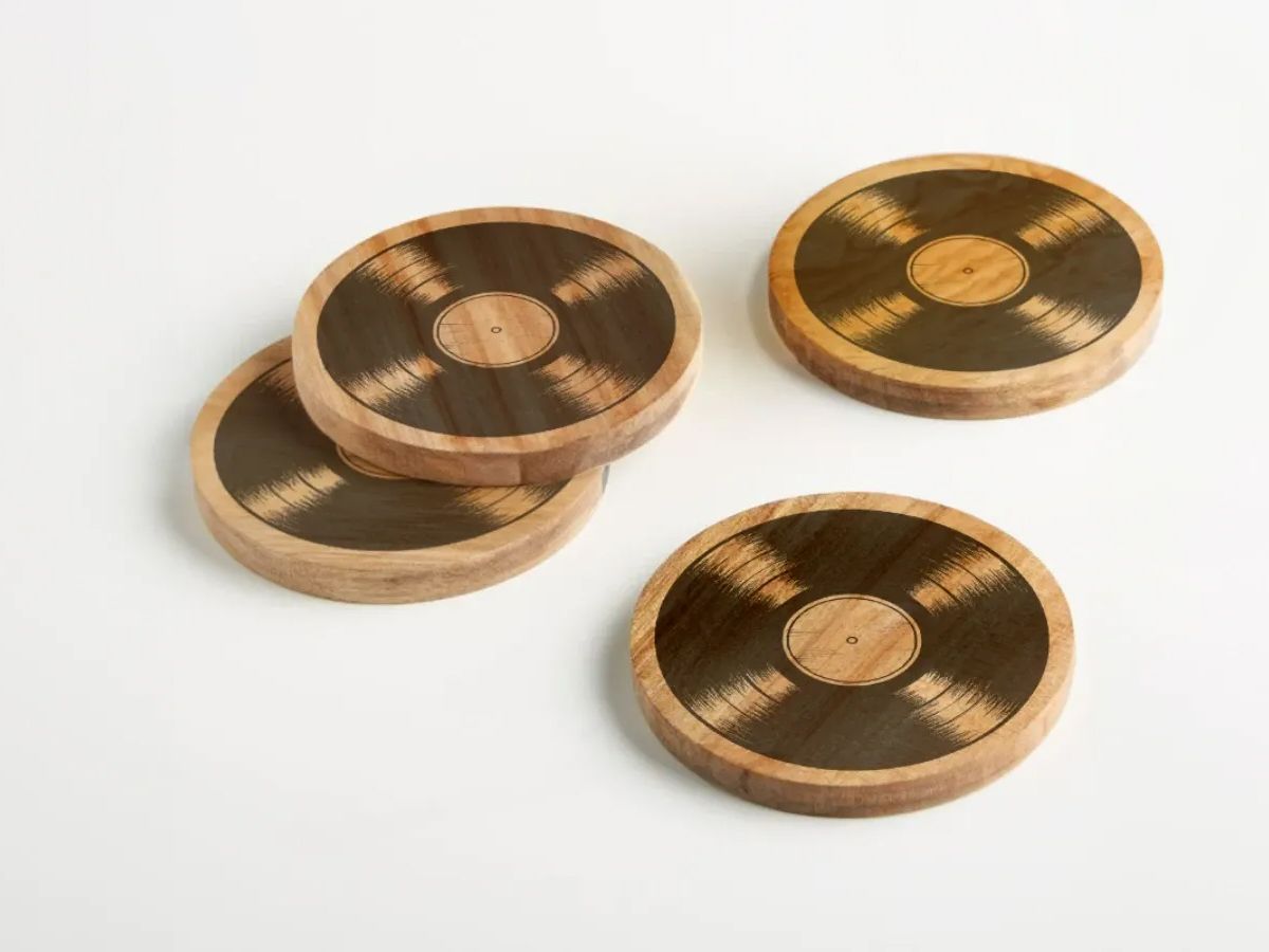 A stack of wooden coasters with a vinyl record on them