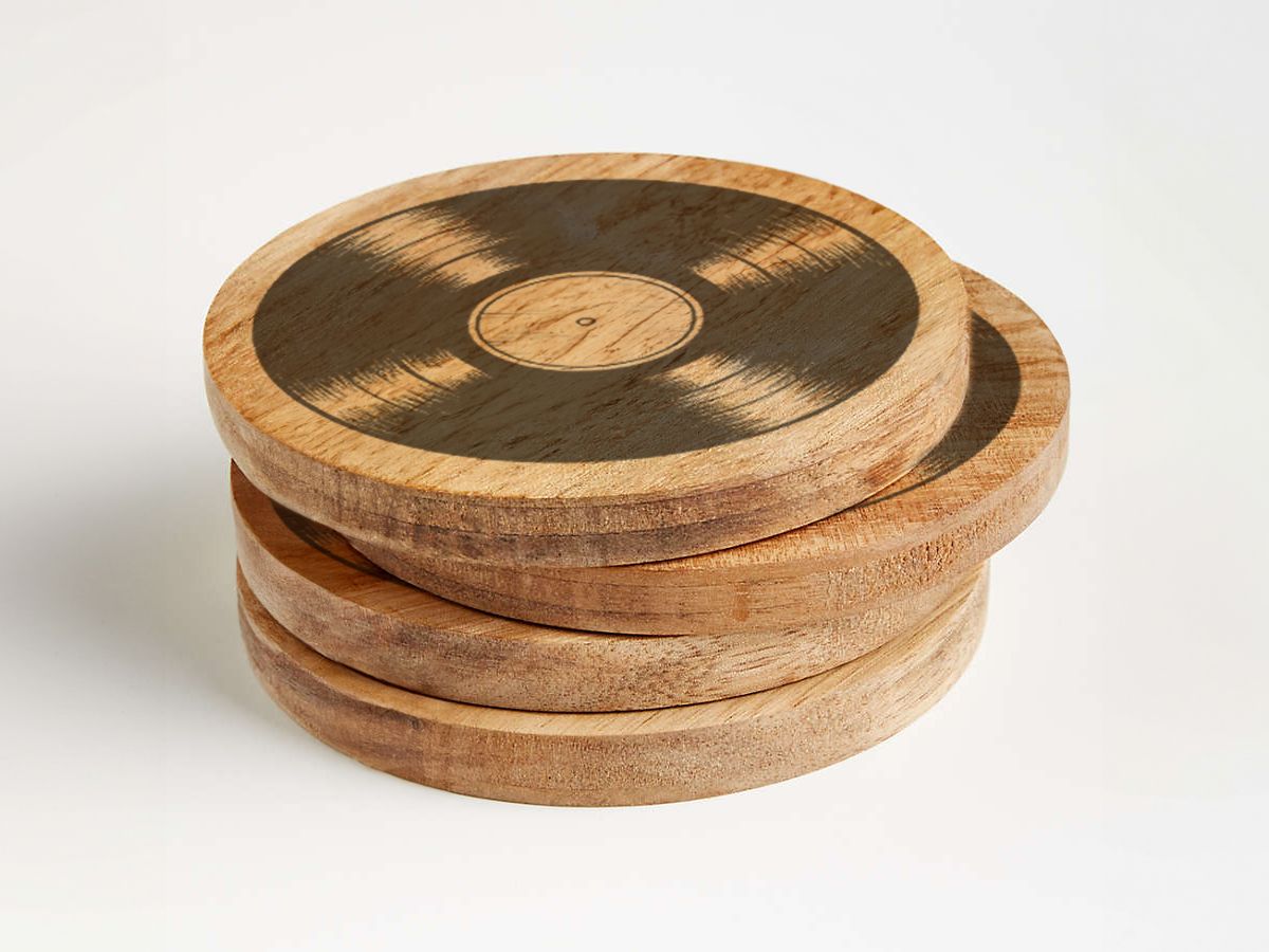 A stack of wooden coasters with a vinyl record on them