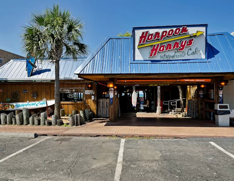 A restaurant with a blue roof and a sign that says harpoon honey 's