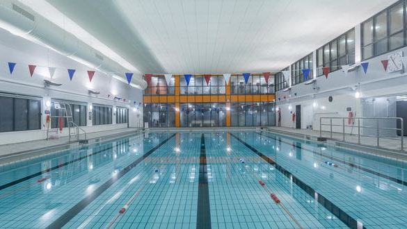 A leisure centre swimming pool with lane ropes