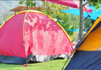 A bright coloured pink tent on a campsite