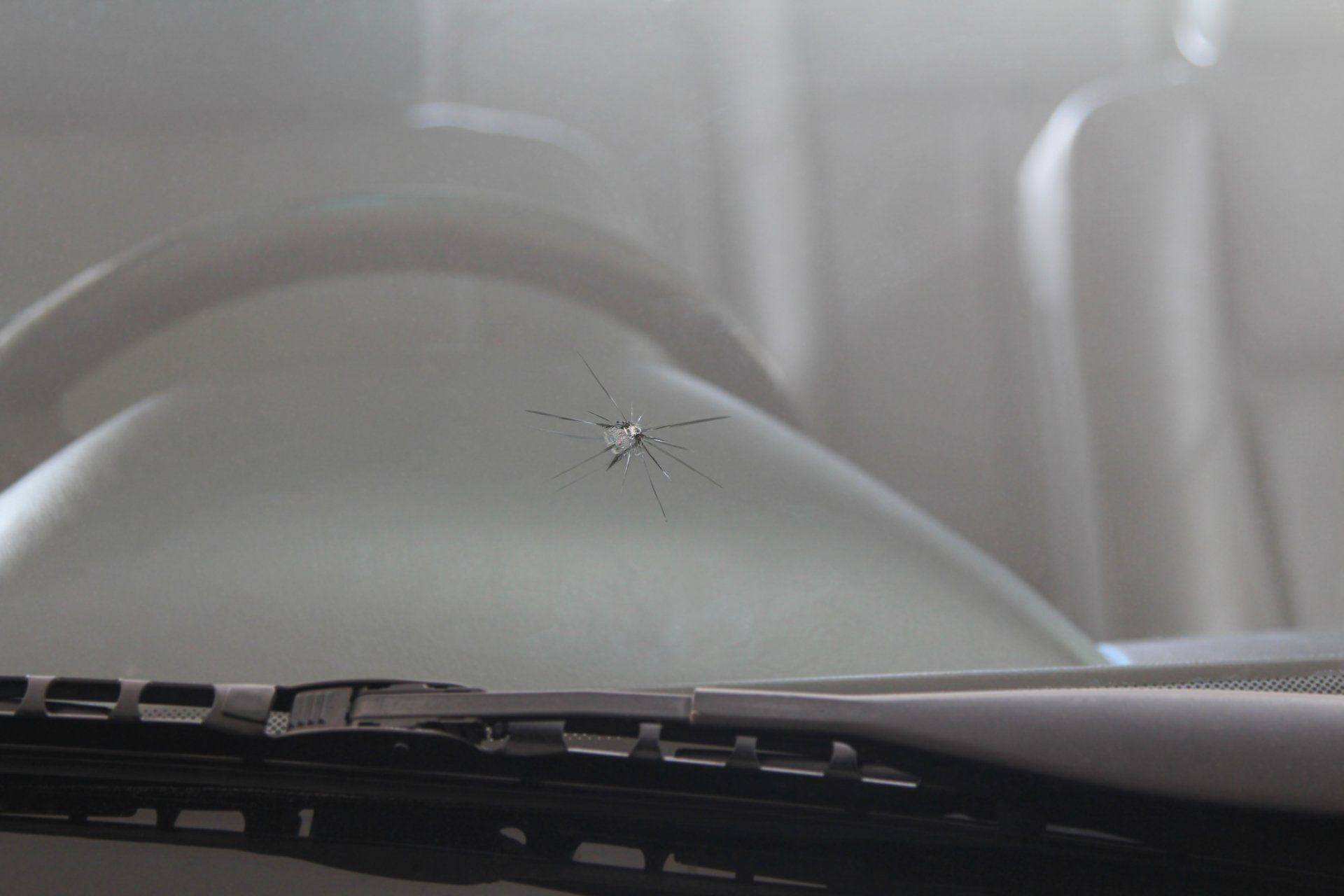 Windshield Replacement — Damaged Car front windshield with Cracks caused by Splashing Debris in Rancho Cordova, CA