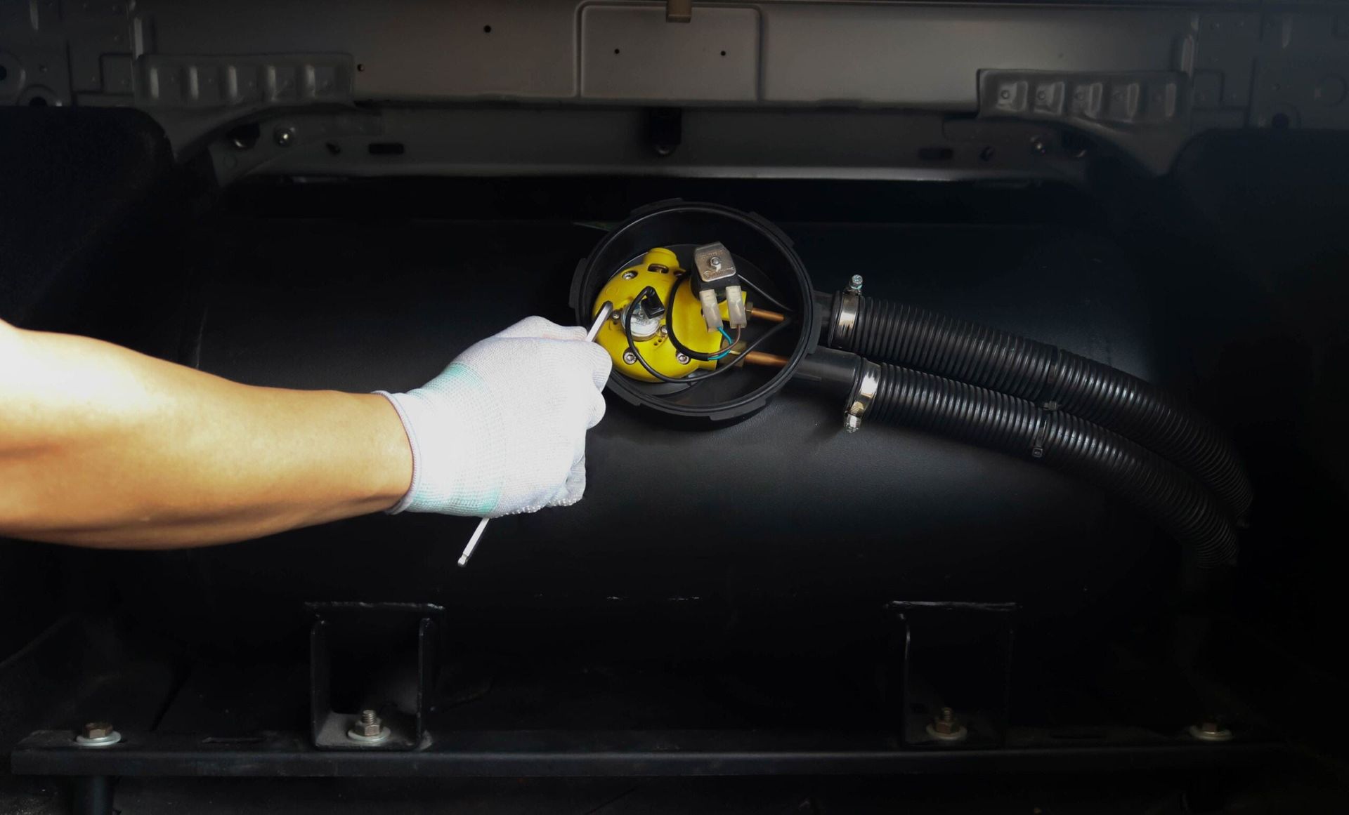 A Person is Holding a Magnifying Glass Over a Gas Tank — Fosters Ace Auto Repairs In Aitkenvale, QLD